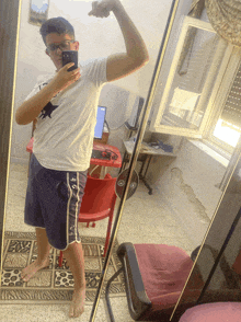 a man taking a picture of himself in a mirror