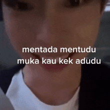 a close up of a person 's face with the words " mentada mentudu muka kau kek adudu "