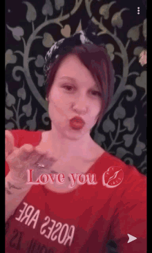 a woman wearing a red shirt that says love you on it