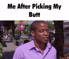 a man in a purple shirt is walking down a street with the caption me after picking my butt .
