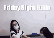 two girls wearing face masks in front of a white board with the words friday night fukin written on it