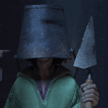 a person wearing a bucket on their head holding a trowel