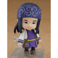 a figurine of a girl with long hair and a purple headband