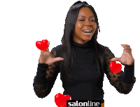 a woman in a black top is holding two red hearts in her hands and the word salonline is on the bottom