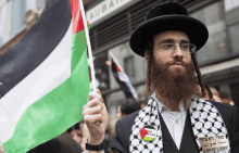 a man with a beard holds a flag that says " the strike " on it