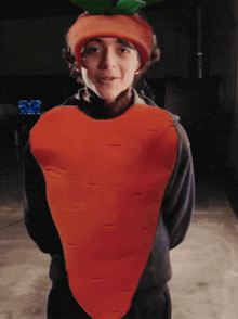 a person dressed as a carrot with a green stem