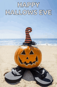 a pumpkin wearing a witch hat sits on a pair of flip flops on a beach