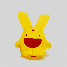 a yellow stuffed rabbit with a red mouth