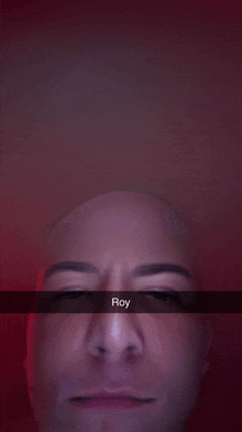 a close up of a man 's face with the name roy written on the bottom