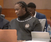 a man wearing a black sweater with the word kings on the front