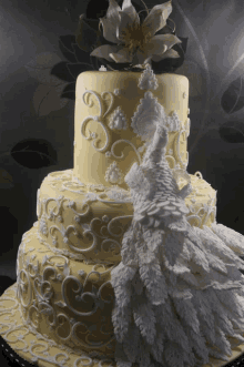 a yellow cake with a white peacock on top of it