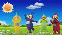 a group of teletubbies are standing in a field