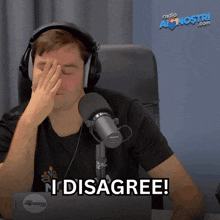 a man wearing headphones and a shure microphone says " i disagree " in front of a laptop