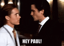 two men in suits and ties are standing next to each other and one of them says hey paul