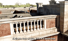 a man laying on the roof of a building with the words " look at this this is a good one "