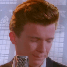 a close up of a man 's face with a microphone in the foreground
