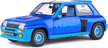 a blue renault 5 turbo toy car with a white background