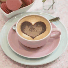 a cup of cappuccino with a heart drawn on the foam