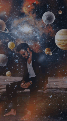 a man in a suit is sitting in front of a galaxy with planets in it