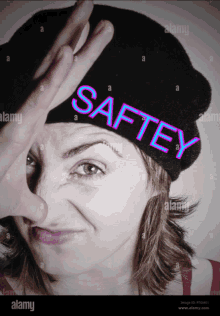 a woman wearing a black hat with the word safety on it