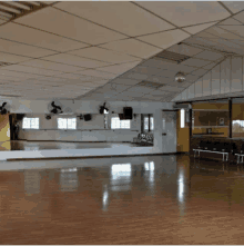 a large empty dance studio with a large mirror