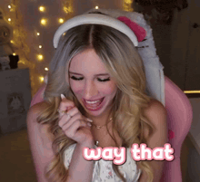 a woman sitting in a pink chair with the word way that above her