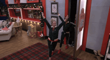 a woman is standing in a room with a sign that says santa 's workshop