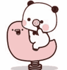 a panda bear is sitting on top of a pink balloon holding a lollipop .