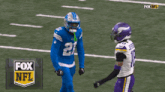 two football players on a field with the fox nfl logo in the background