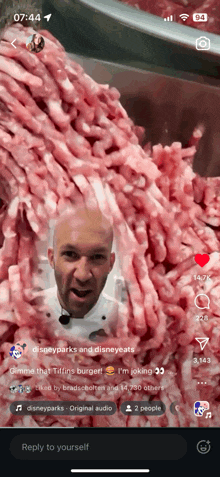 a phone screen shows a video of a man surrounded by meat and says reply to yourself