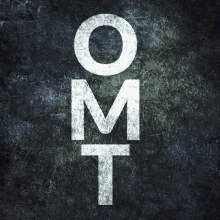 the letters o m and t are written in white on a dark background