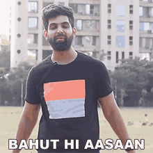 a man with a beard is wearing a black t-shirt that says bahut hi aasaan on it