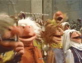 a group of muppets are standing next to each other and one of them says we