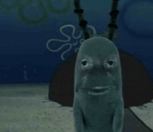 a cartoon character from spongebob squarepants is looking at the camera in the ocean .