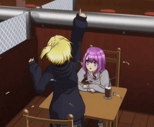 a girl with purple hair is sitting at a table with a man in a black hoodie