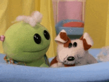 a frog and a dog are sitting on a bed