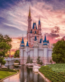 the cinderella castle is surrounded by trees and a body of water