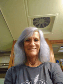 a woman with gray hair is wearing a shirt that says ' old town ' on it