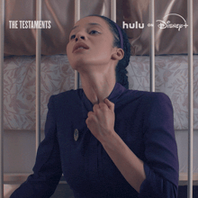 a poster for the testaments on hulu and disney
