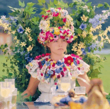 a woman wearing a wreath of flowers on her head