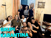 a group of people posing for a picture with the words grupi karantina written above them