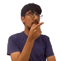 a man wearing glasses and a purple shirt is making a funny face