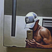 a man wearing a ny hat takes a picture of himself