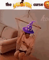 a person wearing a wizard hat is sitting in a hammock .
