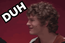 a man with curly hair is making a funny face with the word duh above him