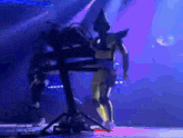 a man in a costume playing a keyboard on stage
