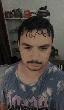 a man wearing a tie dye shirt that says 10319