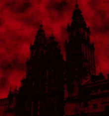 a large building with a red sky in the background is silhouetted against a red sky .