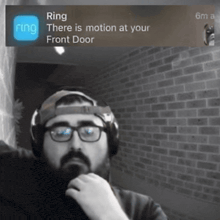 a man wearing headphones is looking at a screen that says ring