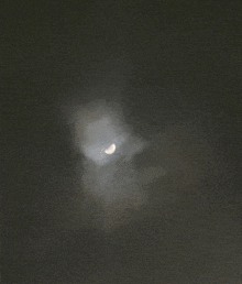 a crescent moon is visible through the clouds